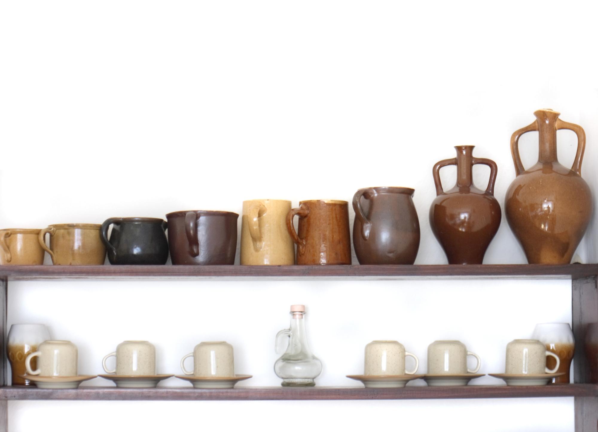 Rustic pantry shelves with preserves and ceramics